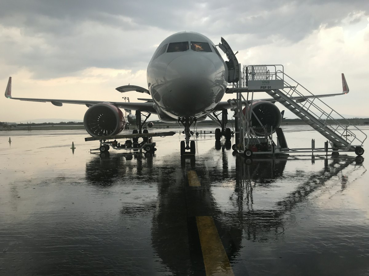 Business jet on a wet apron with boarding stairs