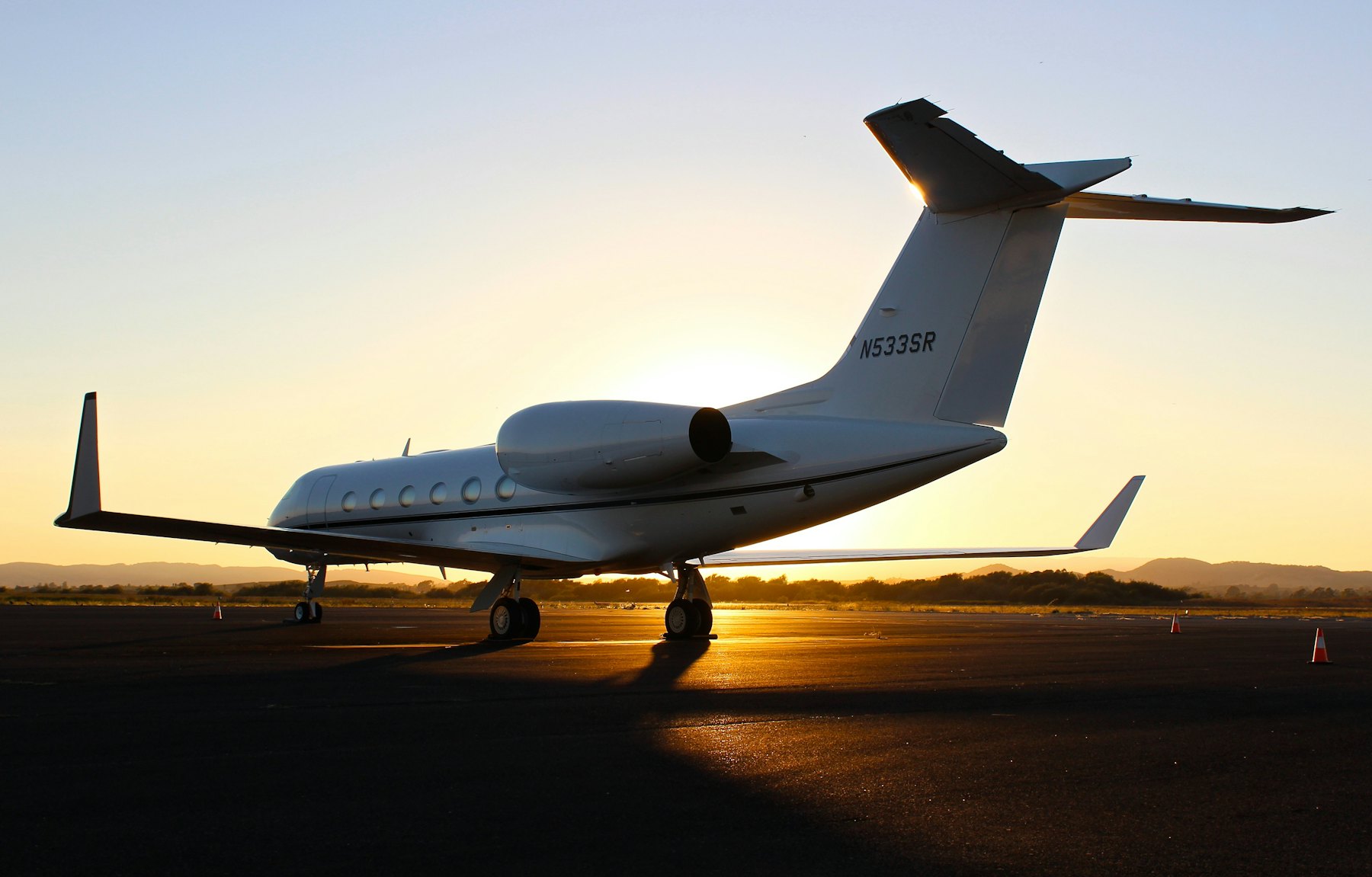 Private jet on the runway at sunset